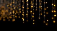 Magical golden string lights hanging against dark background creating festive atmosphere for holiday celebrations and special events.