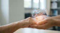 Digital brain hologram floating above cupped hands representing artificial intelligence, machine learning and futuristic technology concepts.