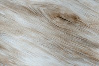 Natural light brown wooden texture with distinctive grain pattern and knot detail creates organic background for design projects and surface mockups.