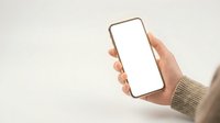Hand holding smartphone with blank white screen mockup in beige knit sweater against neutral background for app presentation and digital design projects.