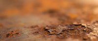 Macro shot of rusty metal surface with oxidized texture and corrosion details, suitable for industrial, grunge, and material design projects.