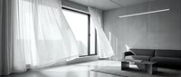 Minimalist modern living room with floor-to-ceiling windows, sheer white curtains, gray sofa, and polished concrete floors for contemporary interior design projects.