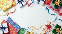 Colorful wrapped gift boxes with ribbons and bows arranged in circle on white background, overhead view for holiday celebration and festive occasion designs.