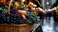 Fresh harvest basket with purple grapes, broccoli and pumpkins at evening farmers market, illuminated by warm string lights creating cozy autumn atmosphere.