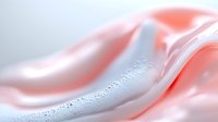 Soft pink and white flowing fabric with water droplets creating elegant waves and smooth curves for luxury beauty and wellness design concepts.