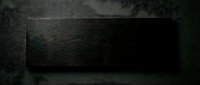 Dark wooden plank with rich grain texture on textured gray background for rustic interior design and woodworking projects.