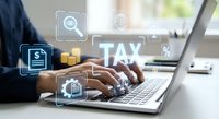 Business professional using laptop for online tax preparation and financial planning with digital interface icons for accounting services.