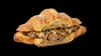Freshly baked croissant sandwich filled with roasted meat and herbs, isolated on transparent background. Ready for bakery menus, food packaging, restaurant graphics, and culinary design projects.