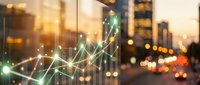 Digital financial growth chart with glowing green arrow trending upward over blurred city skyline at sunset, representing business success and market analytics.