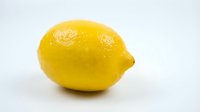 Fresh yellow lemon with water droplets isolated on white background, suitable for food, beverage, and culinary design projects.