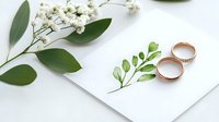 Elegant wedding rings on watercolor greenery card with fresh white flowers and eucalyptus leaves on white background.