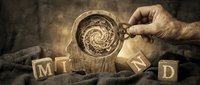 Male hand holding wooden cup with spiral galaxy swirl, surrounded by wooden letter blocks, vintage sepia tones, conceptual art for science, astronomy, creativity, imagination themes.