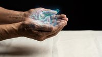 Elderly hands cupping glowing holographic Earth globe with digital network connections representing global technology, environmental care and future innovation concepts.