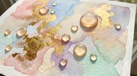 Watercolor abstract painting with golden foil accents and realistic water droplets on textured paper surface creating artistic mixed media composition.