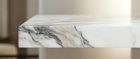 Elegant white marble surface with natural gray veining patterns in modern minimalist interior setting for luxury design projects and architectural visualization.