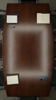 Overhead view of dark mahogany conference table with leather chairs, featuring blank notepads and pen for corporate meeting setup and business workspace design.