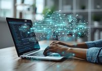Software developer coding on laptop with glowing digital network visualization emerging from screen, showcasing modern technology and connectivity solutions.