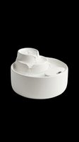 White ceramic pet water fountain with flowing water stream, isolated on transparent background. Ready for e-commerce, product mockups, pet care websites, and design projects.