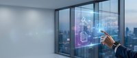 Business professional interacting with futuristic holographic interface displaying digital icons and data analytics in modern office with city skyline view.