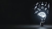 Light bulb with glowing brain and science symbols floating above on dark background representing innovation, creativity and scientific discovery.
