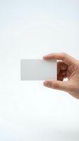 Hand holding blank white business card mockup on clean background for branding and corporate identity design projects.