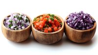 Three wooden bowls filled with colorful diced vegetables including purple onions, red tomatoes with herbs, and purple cabbage on white background.