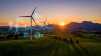 Wind turbines generating renewable energy at sunset with digital technology icons overlay representing sustainable power innovation and smart grid systems.