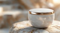 Elegant white cosmetic cream jar with golden rim on marble surface in warm beige tones, luxury skincare product photography with soft focus background.