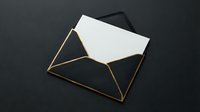 Elegant black envelope with gold edges containing white blank card on dark background for luxury correspondence and invitation design.