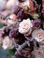 Romantic floral arrangement featuring blush pink and deep purple roses with delicate astilbe flowers creating elegant contrast for wedding and special occasions.