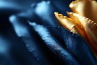Macro shot of golden yellow rose petals against dark blue background creating dramatic contrast and ethereal mood, soft focus artistic floral photography.