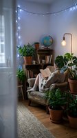 Cozy reading nook with string lights, potted plants, wooden shelves, globe, and comfortable armchair in warm ambient lighting for home decor and interior design.