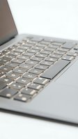 Close-up of laptop keyboard with shallow depth of field, isolated on white background. Suitable for technology, business, and computing design projects.