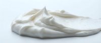 Creamy white whipped dairy topping with soft peaks and smooth texture, isolated on white background for culinary, baking, and food styling projects.