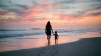 Mother and child walking hand in hand on beach at sunset with pink orange sky reflecting on wet sand and gentle waves washing shore creating peaceful moment.