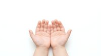 Open cupped hands gesture on white background showing palms up in receiving or offering position for charity, prayer, giving concepts.