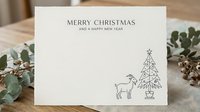 Festive greeting card with minimalist line art featuring reindeer and geometric tree design, surrounded by natural greenery and dried botanicals on wooden surface, perfect for holiday stationery and seasonal marketing materials.