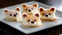 Adorable bear-shaped macarons with caramelized tops and chocolate noses arranged on white plate, sweet French pastry dessert for children party or cafe menu.