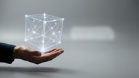 Hand holding glowing geometric network cube with connected nodes and lines on gray background, representing digital technology, data connection, and innovation for business concepts.