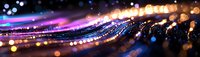 Glowing abstract light trails with bokeh effect in pink, blue and gold colors create dynamic motion on dark background, panoramic composition.