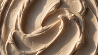 Creamy beige whipped frosting with swirled texture, ideal for bakery, dessert, and confectionery design projects.