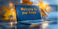 Laptop screen with glowing text Welcome to your future against blurred autumn maple leaves background creating inspiring motivational atmosphere.