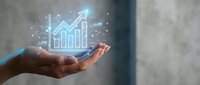 Businessman hand holding glowing upward arrow and bar chart hologram, representing financial growth, investment success, and business analytics for corporate strategy.