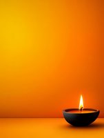 Burning candle in black ceramic bowl against vibrant orange gradient background creating warm atmospheric lighting and peaceful ambiance for spa or meditation setting.