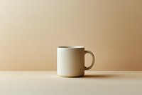 White ceramic coffee mug on beige background with soft shadows and minimalist composition, suitable for product photography and lifestyle marketing.