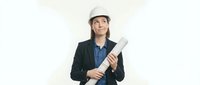 Female architect or engineer of mixed ethnicity wearing white hard hat and dark blazer holding rolled blueprints, isolated on white background for professional business and construction design use.
