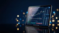 Digital tablet displaying financial trading charts and market data analysis with bokeh city lights background for investment and business applications.