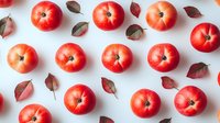 Fresh red apples and autumn leaves arranged in geometric pattern on white background, flat lay composition for healthy lifestyle and seasonal design.