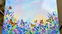 Colorful butterflies and wildflowers border frame on pastel watercolor background for spring summer greeting cards invitations scrapbooking projects.