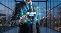 Professional businessman in suit touching holographic thank you message with digital interface elements in modern office environment.